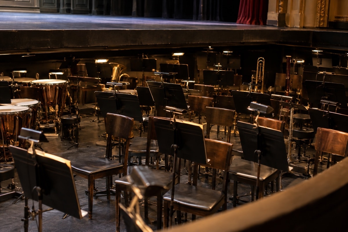 Empty chairs and music stands arranged in an orchestra pit